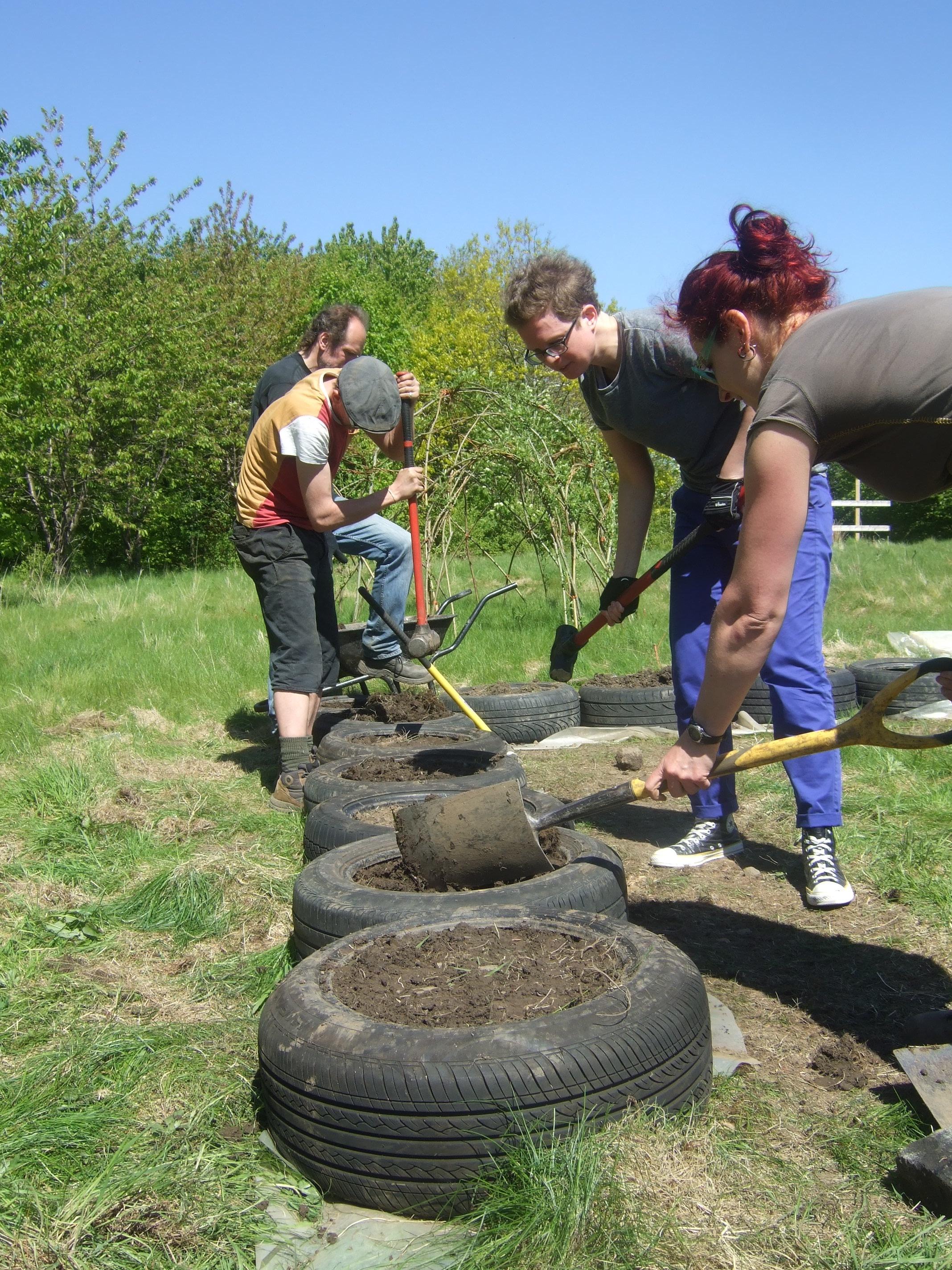 Building a tire wall at Urban Roots Permaculture project